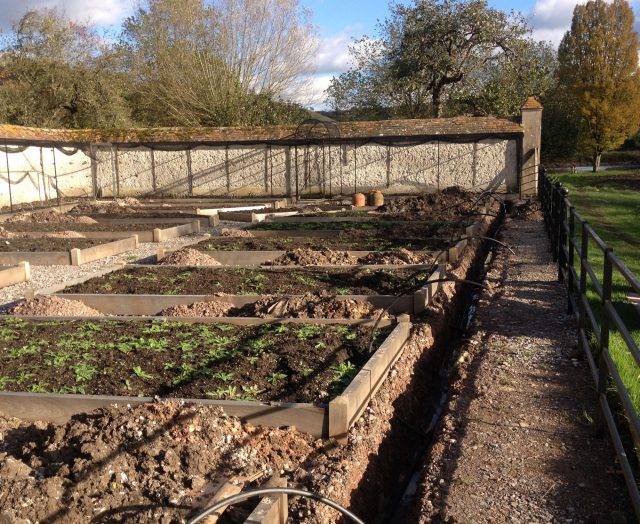 Garden installation with trenches, underground pipework is being laid