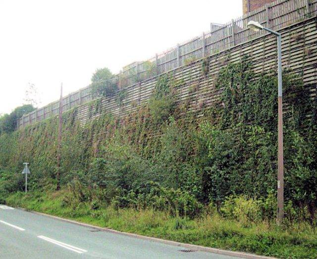 Retaining wall with green planting watered by irrigation system