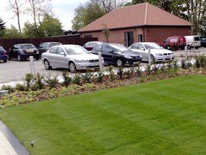 Cars parked by border watered using pressure compensated drip line