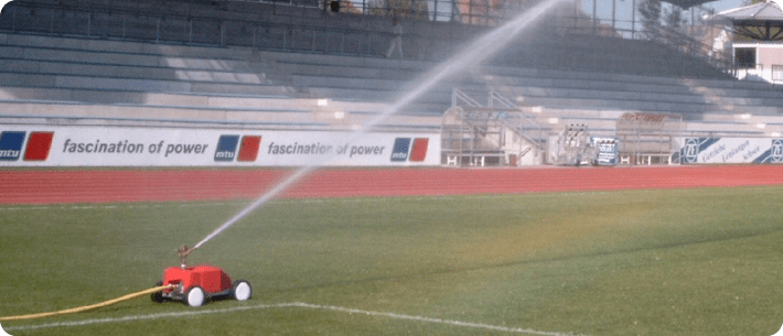 Watering a football pitch with travelling sprinkler