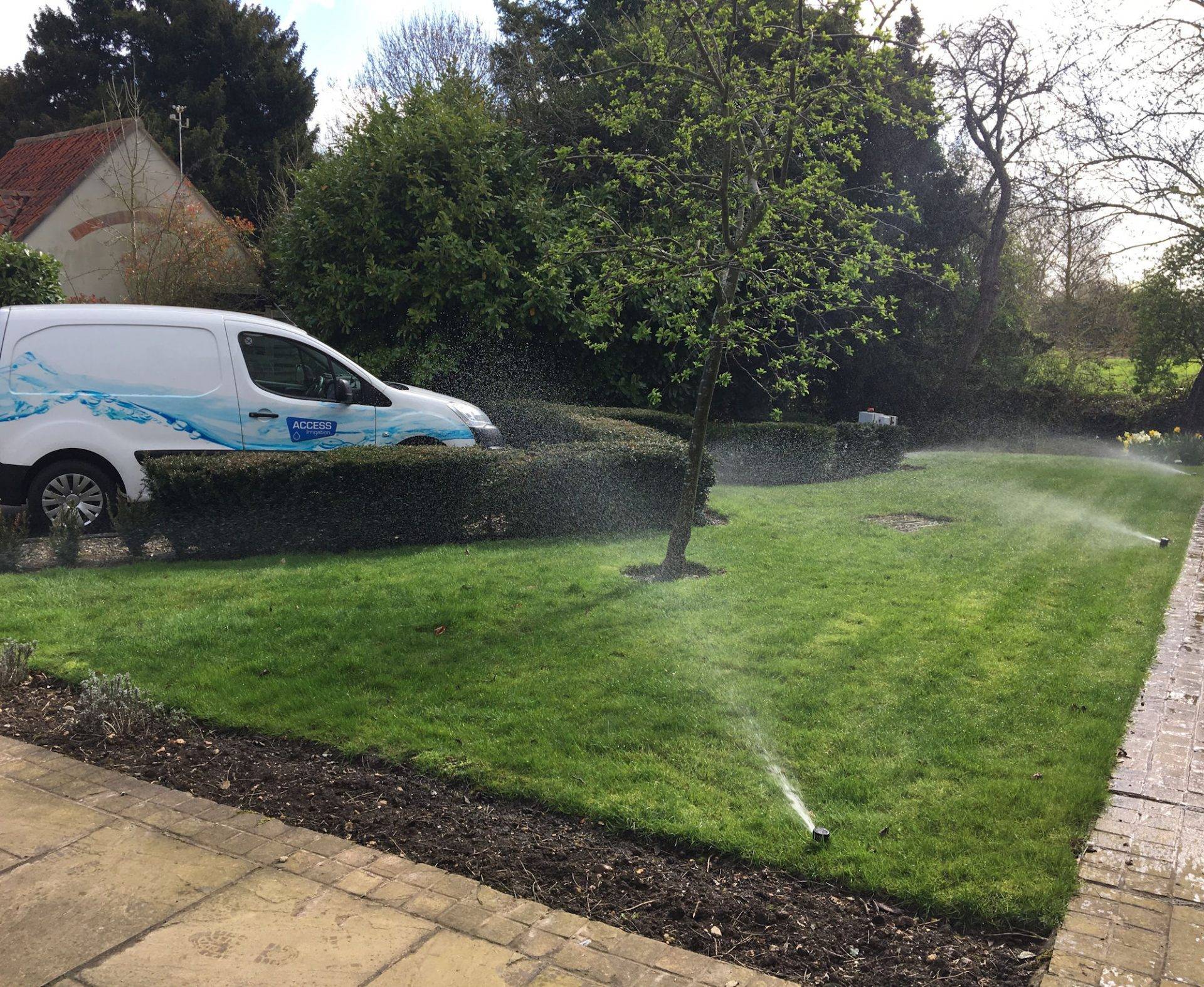 Image of Access irrigation vehicle attending lawn irrigation installation using pop-up sprinklers