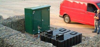 Image of irrigation system, water tanks and controllers being serviced and repaired