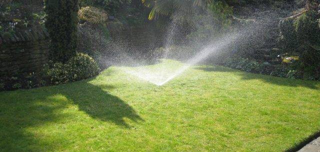 Lawn watering system using pop up sprinkler