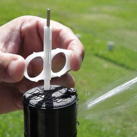 Image of adjusting a sprinkler using Hunter nozzle key