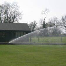 lawn being watered by sprinkler