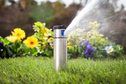 Image of Hunter I-20 Ultra Pop up Sprinkler watering domestic lawn and flowers