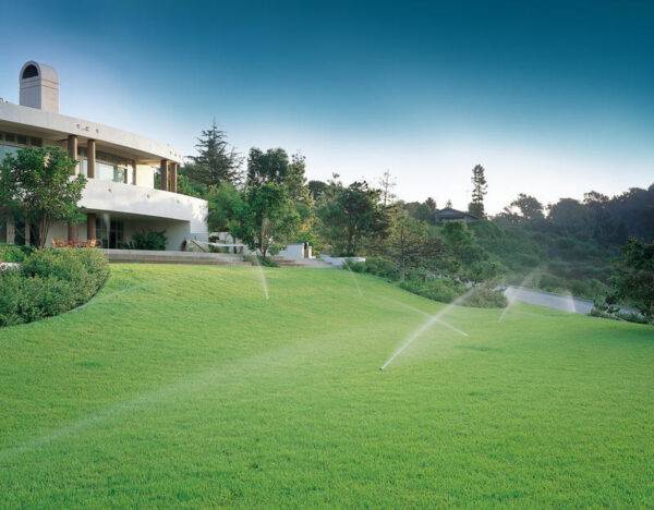 Large domestic lawn area watered by irrigation system with Hunter PGP ultra pop up sprinklers