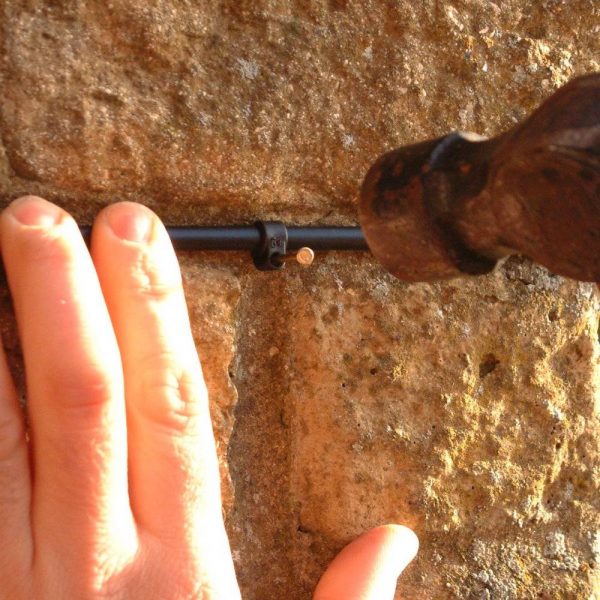 Supply pipe for hanging basket system being mounted to a wall