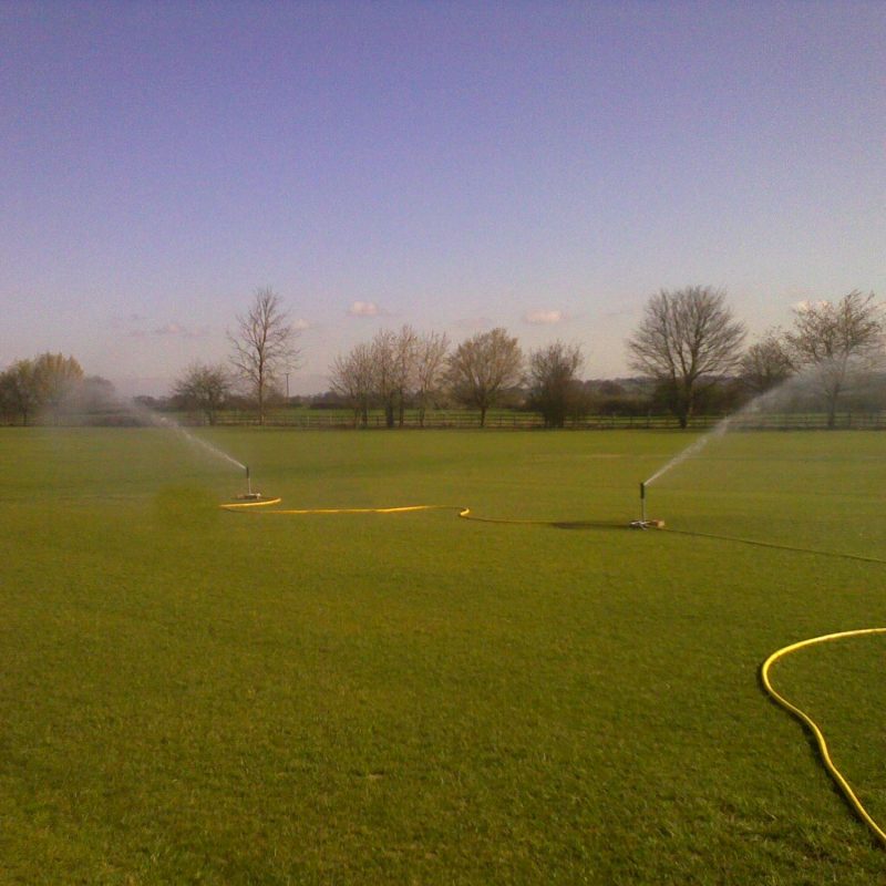 Temporary sprinklers watering sports pitch