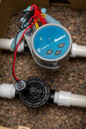 Image of Hunter Node Bluetooth 4 zone controller connected to latching solenoid valve (9v DC) placed in Hunter valve box