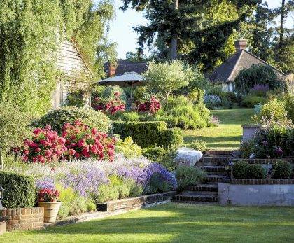 Garden grounds, lawns, planted borders and allotment garden of Shamley Wood House watered by irrigation systems designed and supplied by Access Irrigation