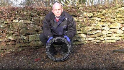 Video of a man showing how to uncoil irrigation pipe